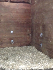 Four rings in stable wall to secure Slow Down Hay Feeder for horses